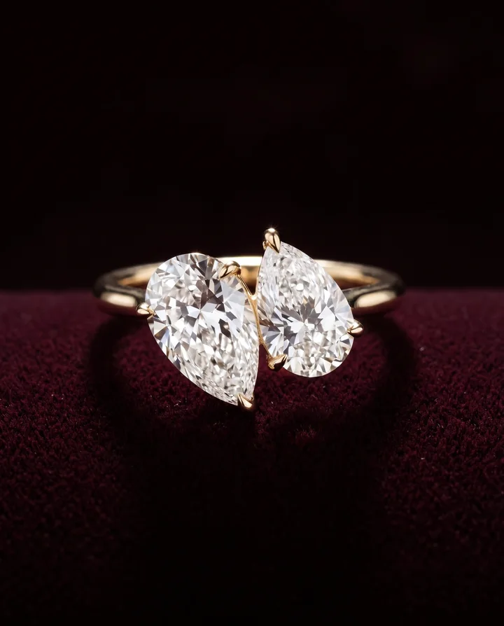 Levendi Jewellers product image: Toi and Moi pear cut twins engagement ring on burgundy velvet